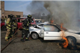 Firefighters with car fire