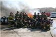 Firefighters posing in front of fire
