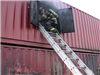 Firefighter climbing into window from ladder