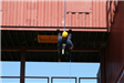 Person Rapelling Down Metal Building