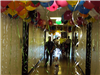 Child Walking Through Hallway Full of Balloons