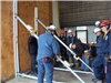 Firefighters Putting Metal Rods Together