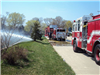 Fire trucks spraying hose