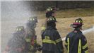 Firefighters training with hose