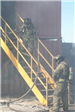 Firefighters walking up stairs to burning building
