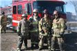 Firefighters posing in front of truck