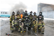 Firefighters posing by fire