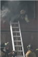 Firefighter leaning out of smoking window