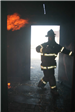 Firefighter in burning house
