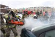 FIrefighter cutting into burning car