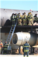 Firefighters on ladder and plane wing