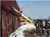 Firefighters putting up ladder