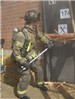 Firefighter using ax to break into door