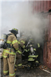 Firefighters going into smoking building