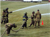 Firefighters spraying hoses