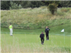 People Standing by Golf Hole
