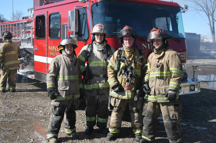 Firefighters posing in front of truck