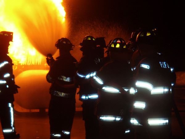Firefighters spraying water onto fire